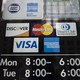 A sign with the logos of various credit-card companies