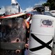 White nationalists shelter behind shields, displaying the Southern Nationalist flag.