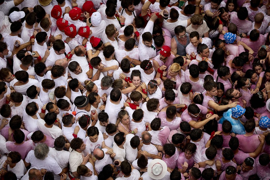 An elevated view of a large crowd of festival-goers packed closely together