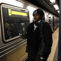A conductor stands next to a stalled train in New York City after a power failure stopped multiple subway lines in April 2017.