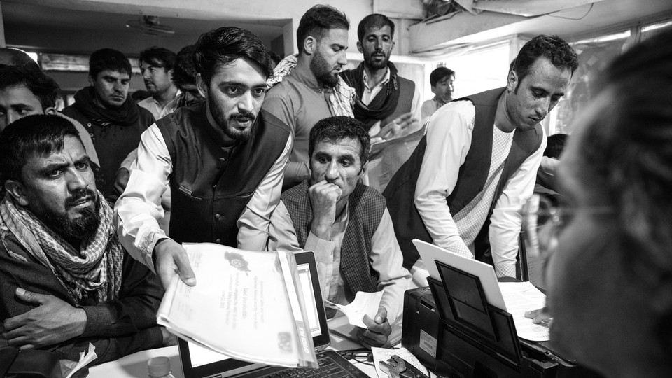 Applicants for a Special Immigrant Visa crowd into a Kabul internet cafe on August 8, 2021.