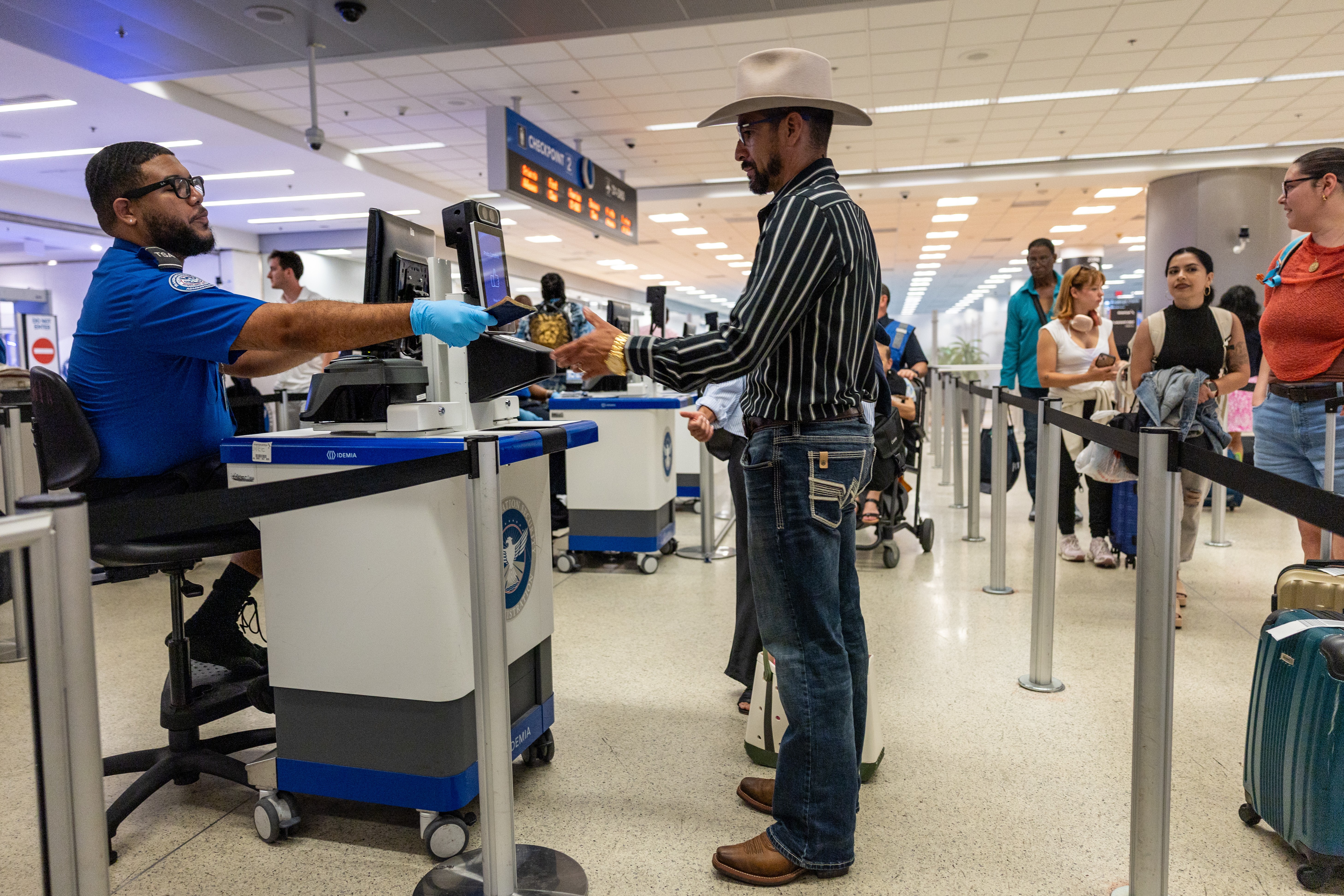 A man passes through a TSA checkpoint at an airport.