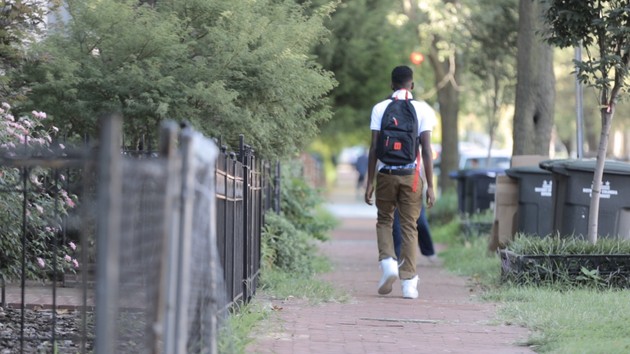 An African American student walks to school in the relatively diverse, though still segregated, neighborhood of Bloomingdale in Washington, D.C.