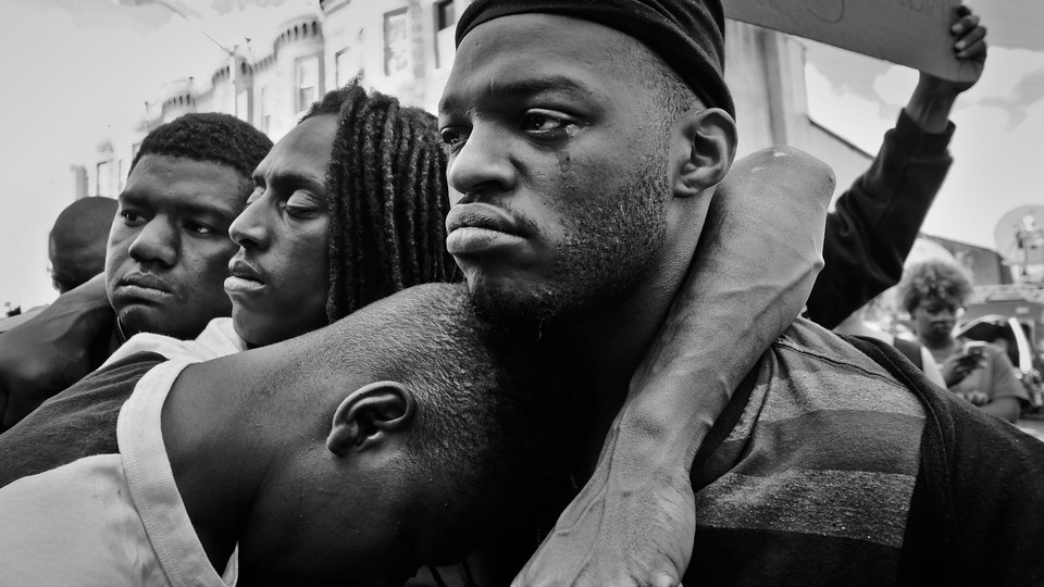 Emotional protesters embrace in West Baltimore over the death of Freddie Gray, 25, who died in police custody in 2015.