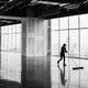 A person mopping the floor of an empty building