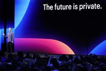 Mark Zuckerberg speaks onstage in front of a sign that says "The future is private."