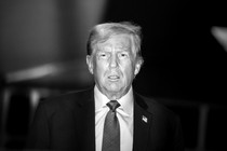 A black-and-white photograph of Donald Trump wearing a suit and tie, looking toward but past the camera.