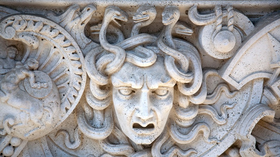 A medusa head carved in stone