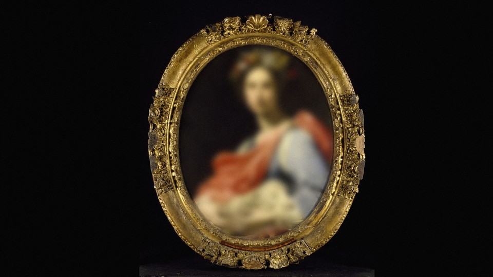 A blurred portrait in a gilded frame