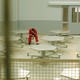 a color photographs of a man wearing a prison jumpsuit sitting alone in a lunch room