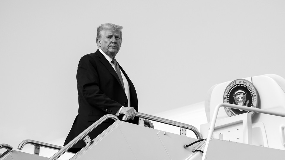 A black-and-white image of Trump looking toward the camera with the presidential seal in the background
