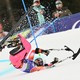 A seated para Alpine skier on a fast run crashes and tumbles on a ski slope.