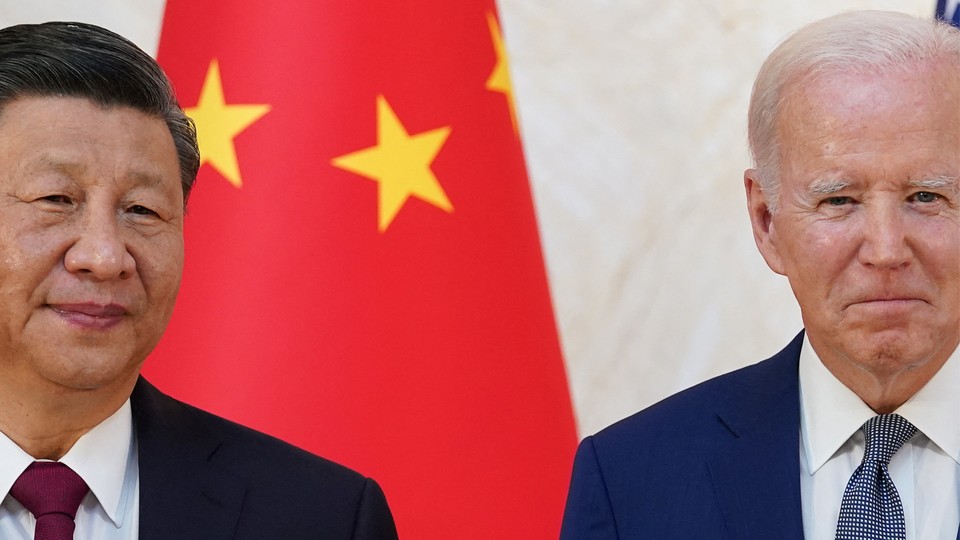 A photograph of Chinese leader Xi Jinping and U.S. President Joe Biden in front of a Chinese flag