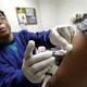 A health worker injecting a flu shot into a patient's arm