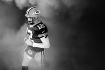 Aaron Rodgers walking on a football field