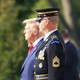 Donlad Trump stands next to an Honor Guard member during a visit to the Arlington National Cemetery