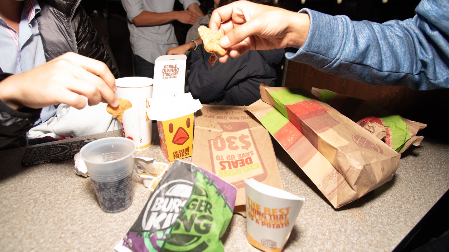 Students share late-night French fries at the Burger King near Northwestern University.
