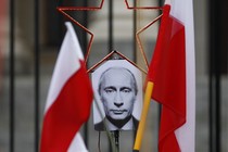 A photo of Russian President Vladimir Putin between two Polish flags