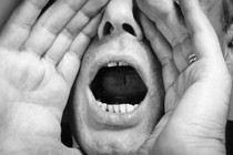 Person cupping their mouth to yell