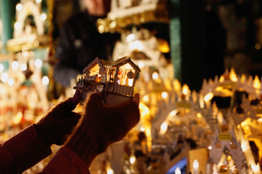 A shopper looks at a Christmas ornament.