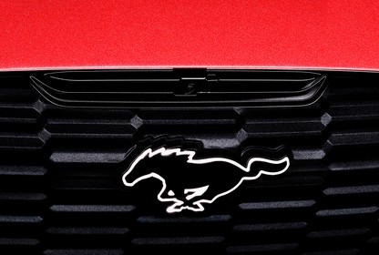 the front bumper of a Ford Mustang Mach-E, showing the galloping-horse logo