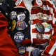 A Pete Buttigieg supporter, seen from the neck down, wears an American-flag jacket covered in pro-Buttigieg buttons.