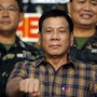 Philippine President Rodrigo Duterte makes a "fist bump", his May presidential elections campaign gesture, with soldiers during a visit at Capinpin military camp in Tanay, Rizal in the Philippines August 24