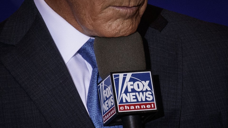 Close-up picture of Donald Trump's mouth speaking to a Fox News microphone.