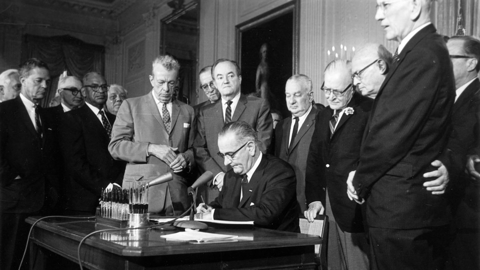 President Lyndon Johnson signs the Civil Rights Act on July 2, 1964.