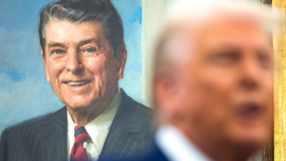 Photo of Donald Trump in front of a painting of Ronald Reagan.