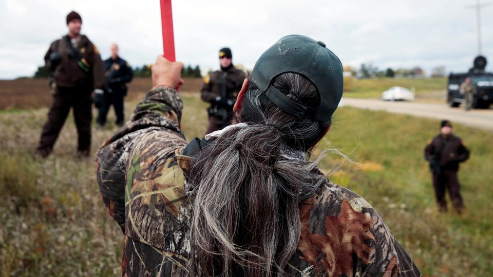 Michael Markus of Pine Ridge Indian Reservation in South Dakota with police at a rally against the Dakota Access pipeline in October.
