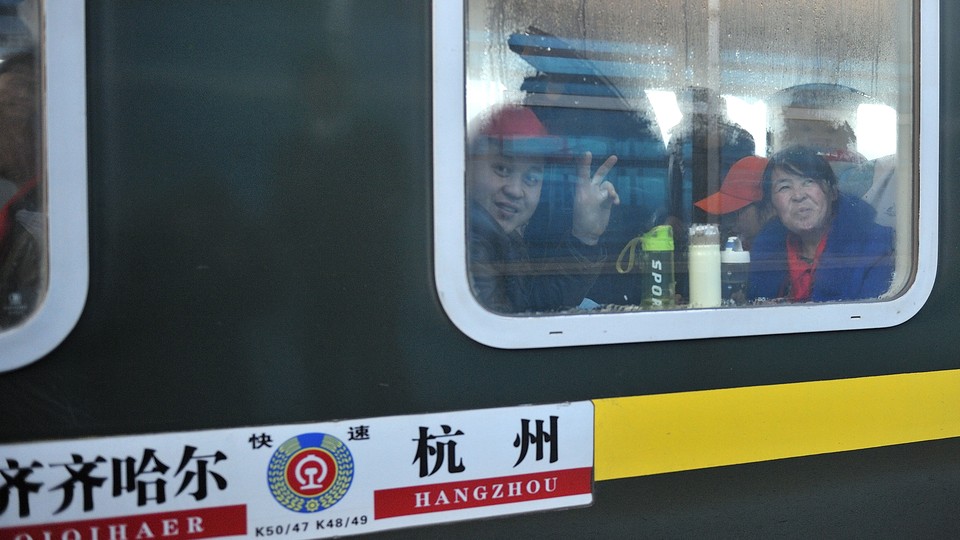 Migrants workers take a train from the city of Hangzhou to Qiqihar to celebrate the Spring Festival holiday in 2018.