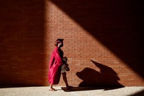 A student preparing for commencement at Tusk​egee University