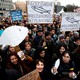 People with signs shaped like sardines gather in Italy.