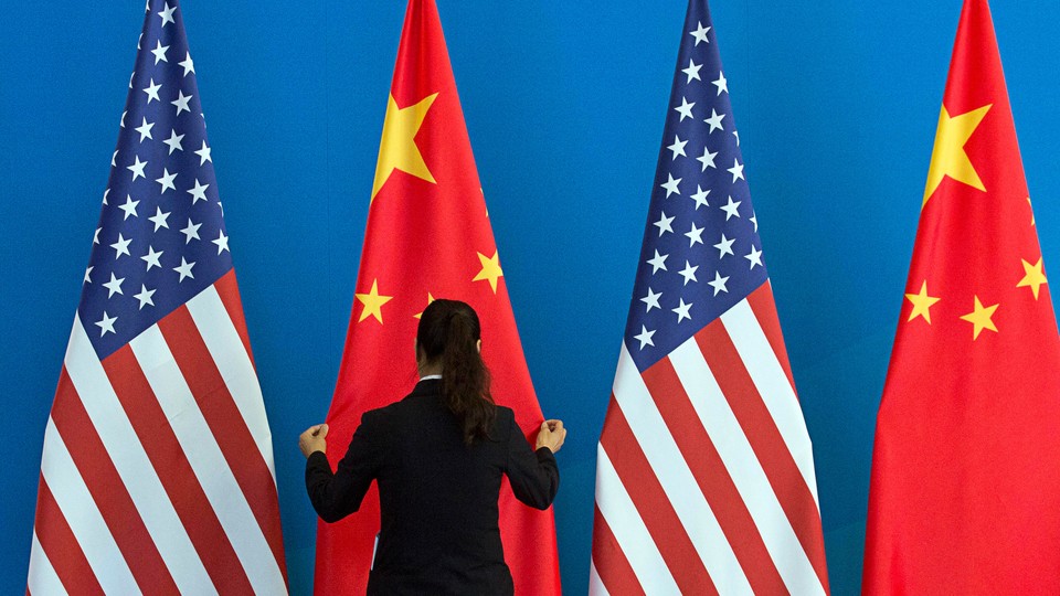 A photo of U.S. and Chinese flags staged for a diplomatic meeting