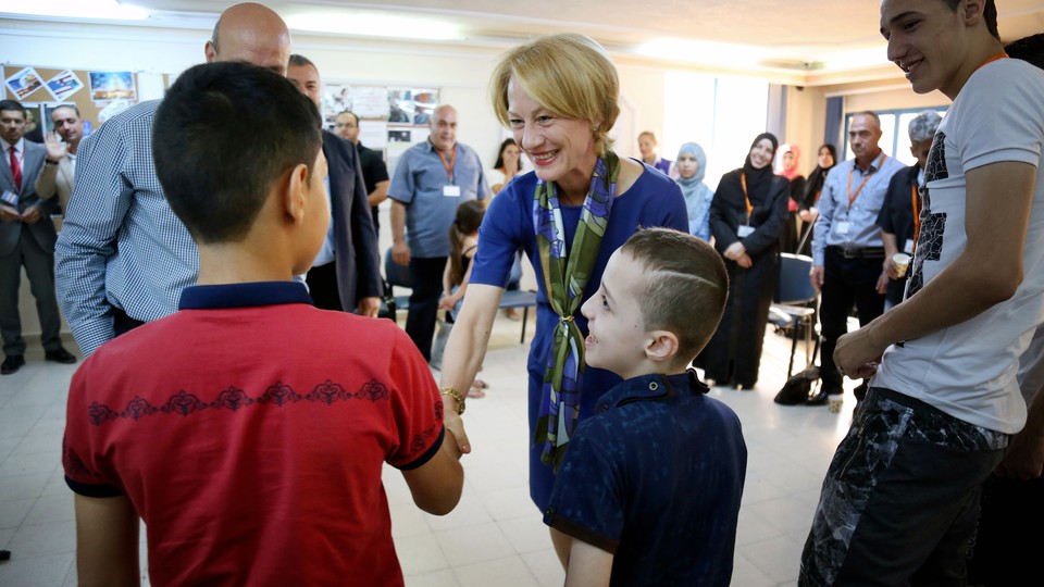 Alice Wells, the U.S. Ambassador to Jordan, greets members of the Jouriyeh family before they leave for resettlement in San Diego, California 
