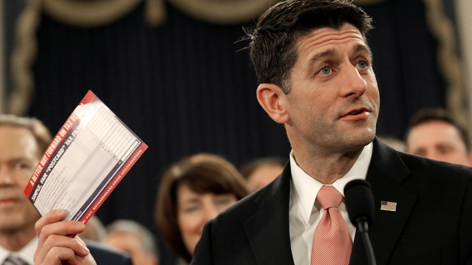 House Speaker Paul Ryan holds a sample postcard-size tax form.