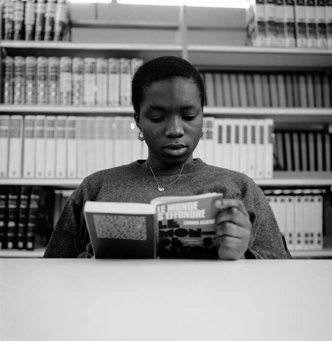 A young woman reads a book