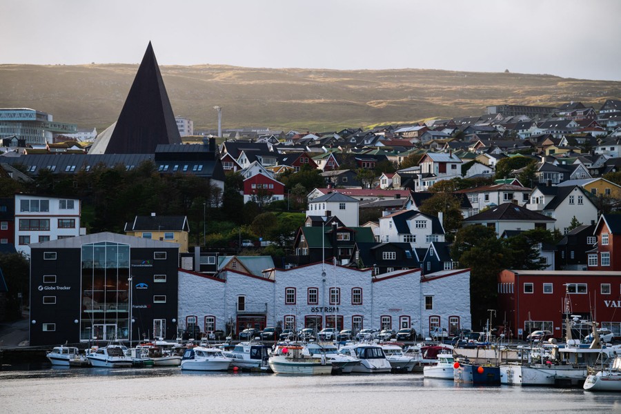 The buildings of a small city are seen from a harbor.