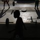 Silhouettes of boys lifting weights