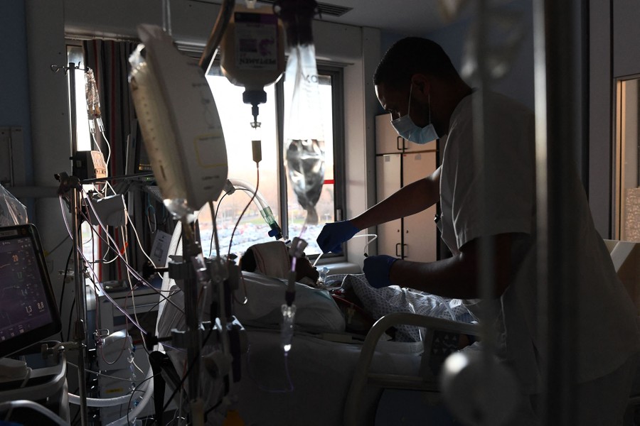 A medical worker attends to a COVID-19 patient in a hospital.