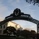 A silhouette of a UC campus gate