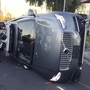 A flipped over grey self-driving SUV