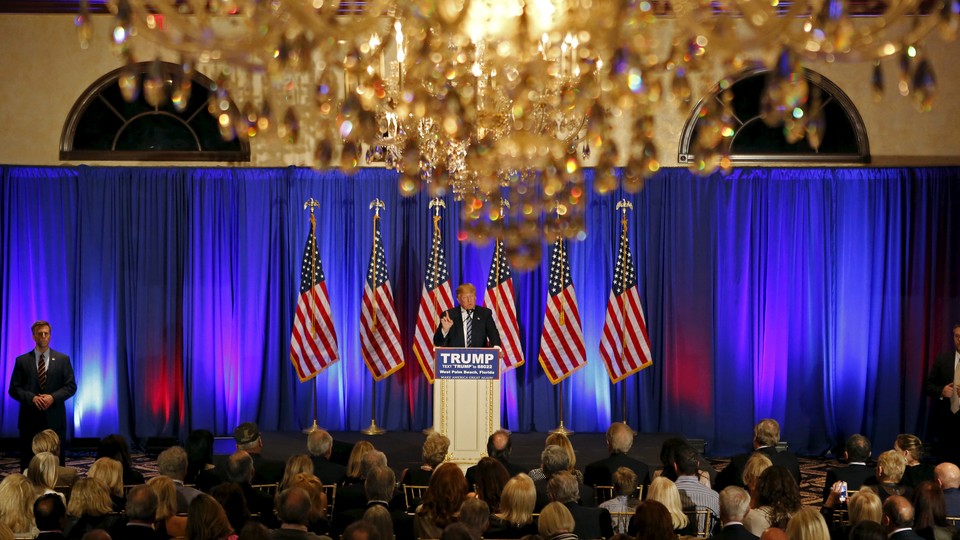 Donald Trump speaks beneath chandeliers at a press event at his Trump International Golf Club in West Palm Beach in March.