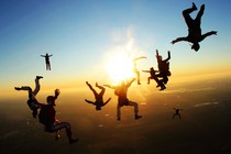 A group of skydivers pose as they fall through the air