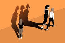 Two women walking, leaving a third woman behind