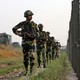 India's Border Security Force soldiers patrol along the fenced border with Pakistan on February 26, 2019.