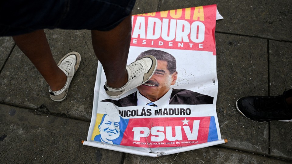 A foot stepping over a sign with Nicolás Maduro's face