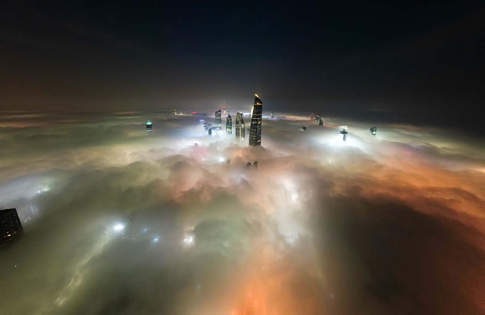 An aerial view of buildings shrouded in fog in Kuwait City