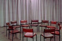 A photo of a circle of empty chairs